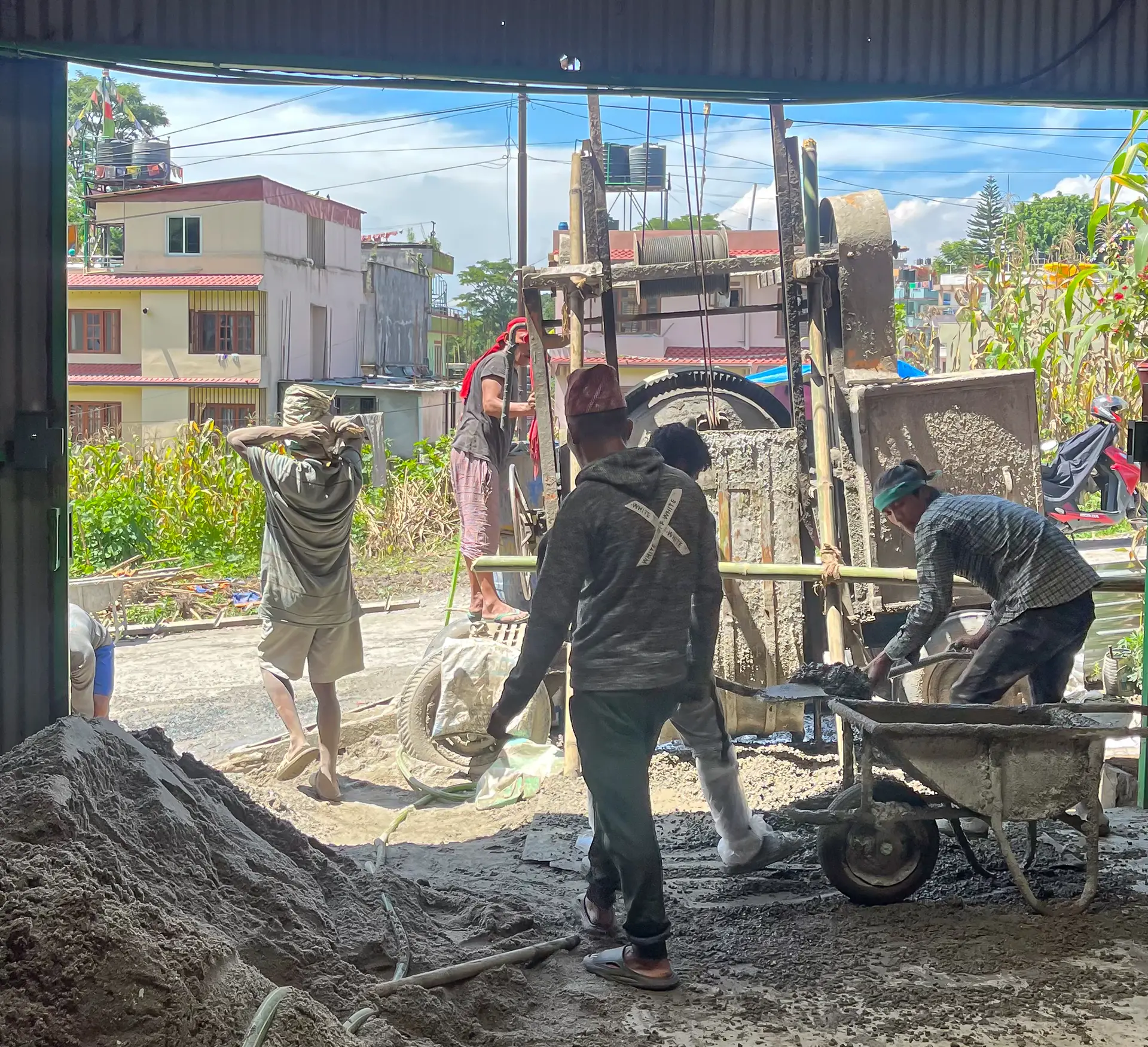 Group of workers with heavy machinery building the NEVI Factory in Nepal