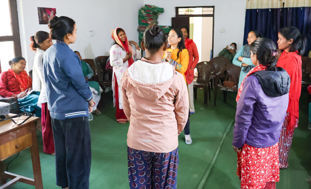 Community workshop session at Pilot Site 2 in Bardiya, Nepal, with participants standing in a discussion circle.”