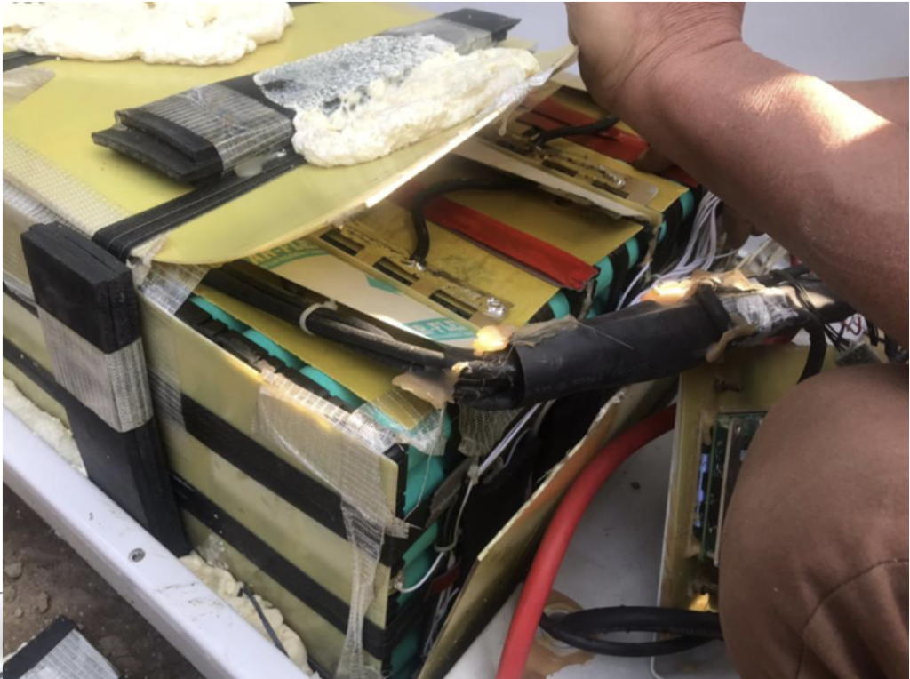 Close-up showing worn battery wiring and connection points on an existing battery system in Nepal