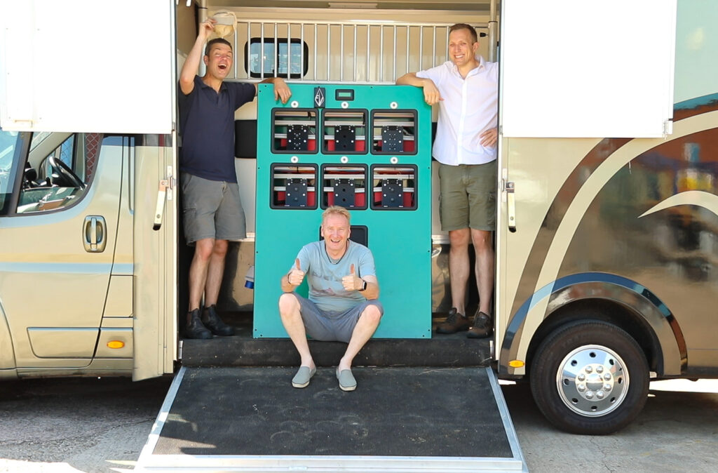 Philip Tyler, David Tetlow and Paul Kerby cheering on as they stand next the the loaded terminus, battery charger ready to take to the UK Pilot site.