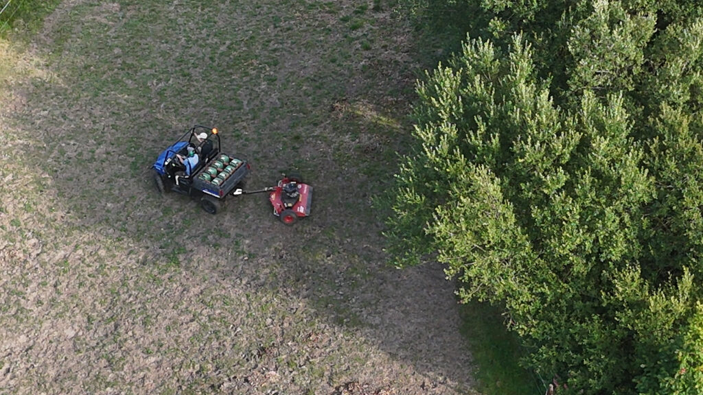 The blue polaris with a mower on the back working on the UK Pilot Site