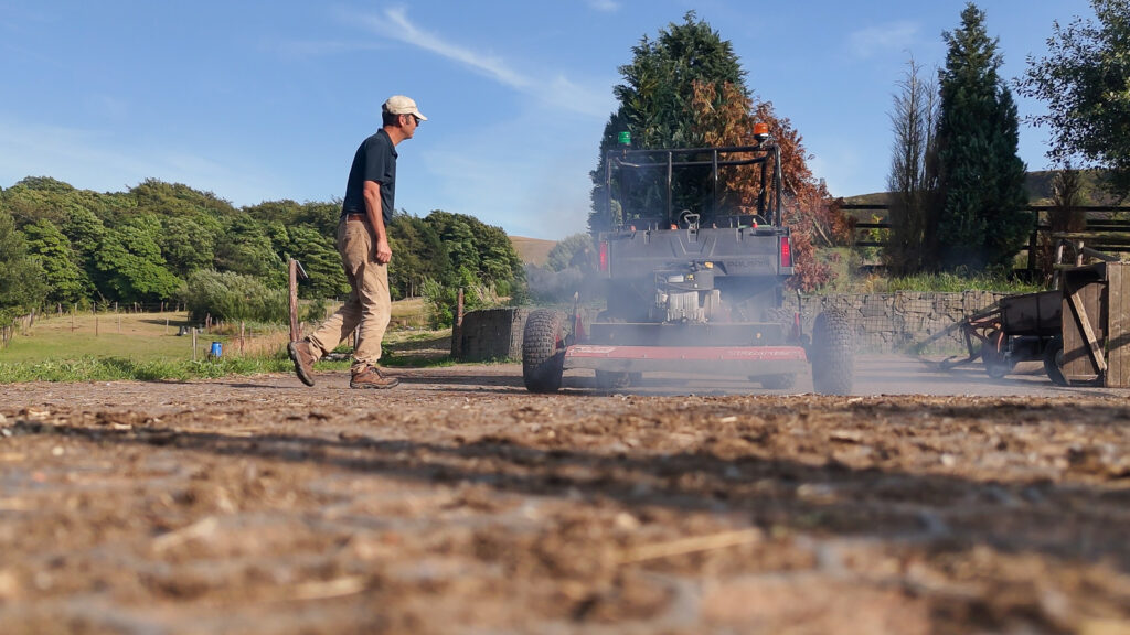 Philip Tyler starting the mower on the back of the polaris at the UK Pilot site
