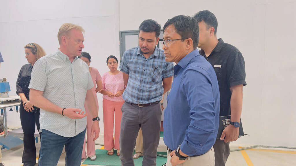 A deep discussion happening between a group of four between the Practical Action Team and Global Solutions at the NEVI factory